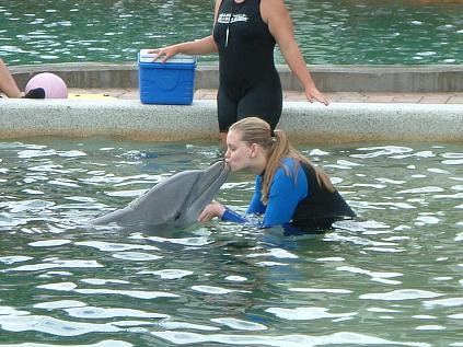 Girl Kissing A Dolphin